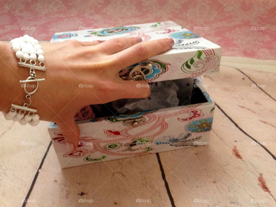 Women hand opening a beautifully decorated box 