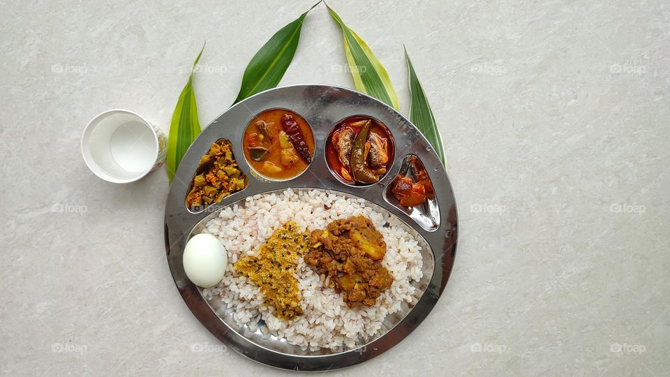 Healthy and tasty Indian Meal, Beautiful presentation of Indian food, spicy foods, vegetarian and non-vegetarian food, Rice Thali, Egg, best food, tasty foods, fish curry, sambar, lemon pickle