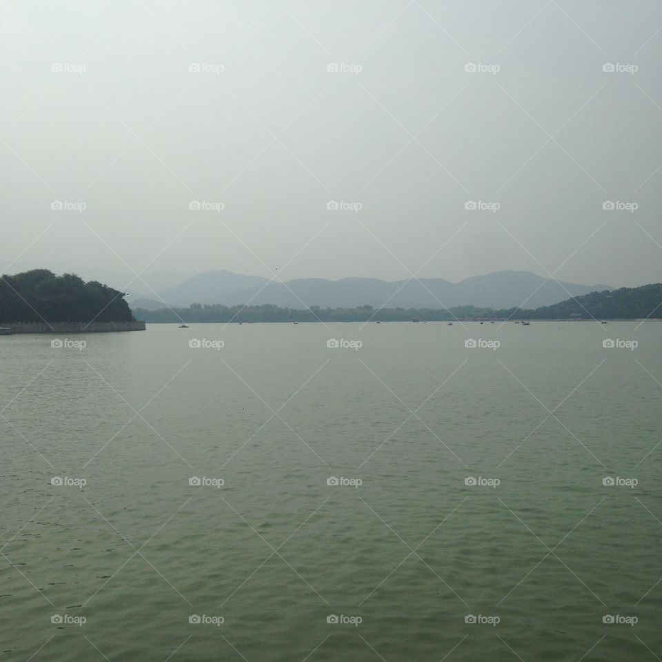 Mountains in Beijing . Mountains in the distance over a lake. Taken in Beijing, China. Enjoy!