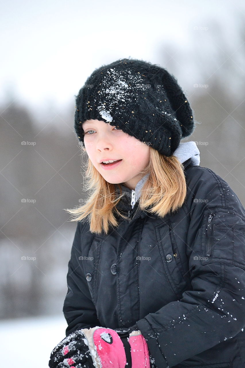 A girl wearing warm clothing in winter