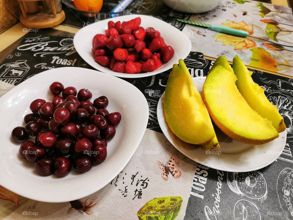 Fruits berry view bio fresh yummy healthy Red strawberry view table day part yellow melon day part cherry dark