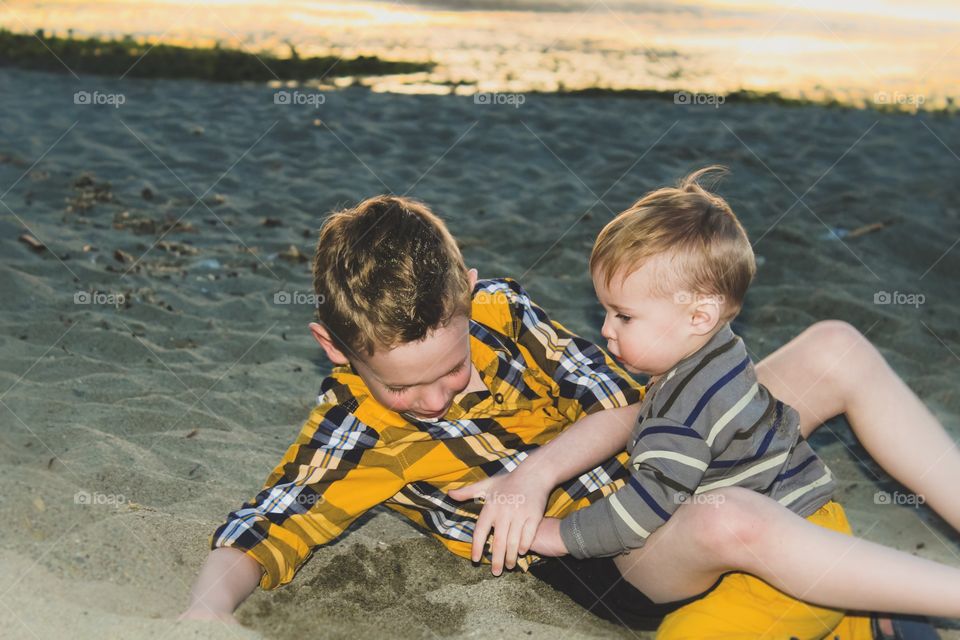 Wrestle time with brother in the soft sand 