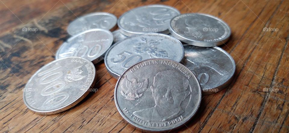 Rupiah coins on an ancient wooden table