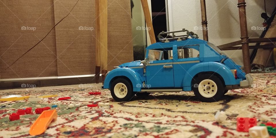 blue Lego Creator Series Volkswagen beetle on rug in living room