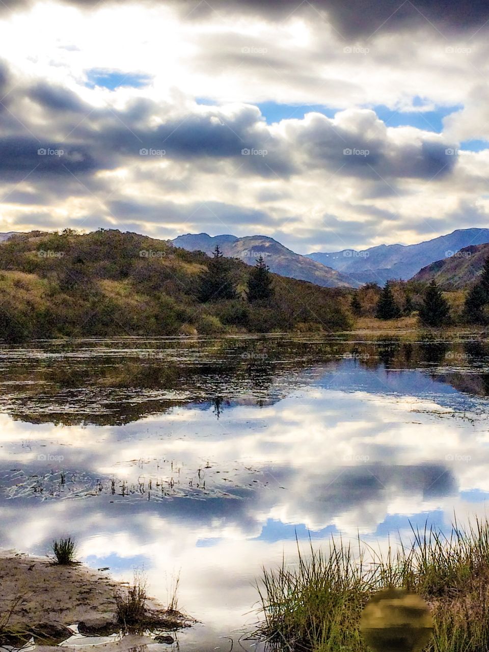 Reflection of clouds and mountain on lake