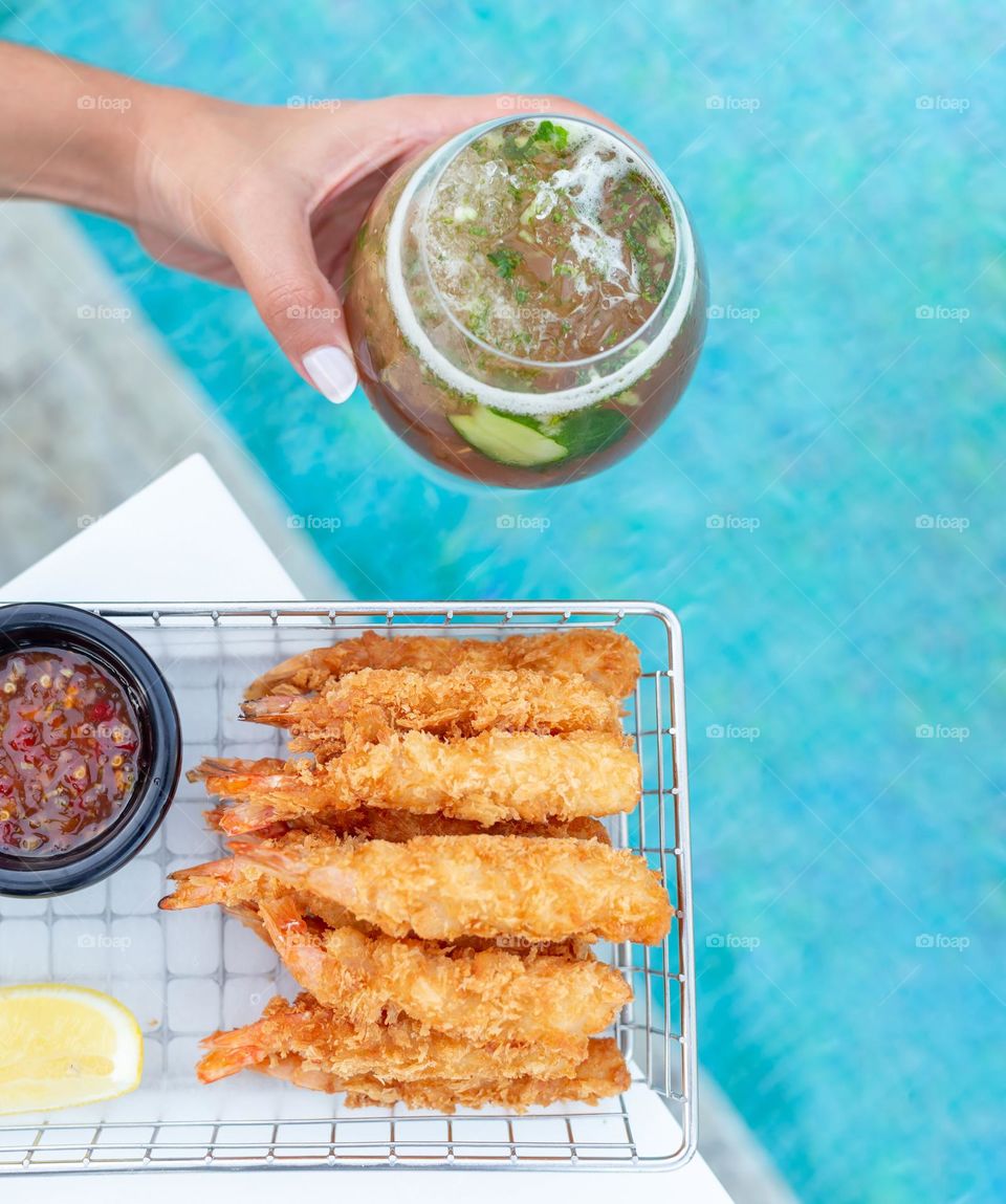 Fresh cocktail and snacks by the pool, summer time