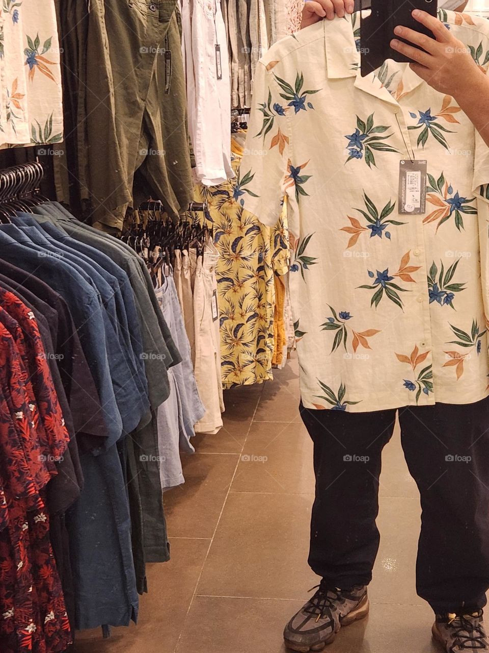 Mirror is refecting the shirt that I was trying on