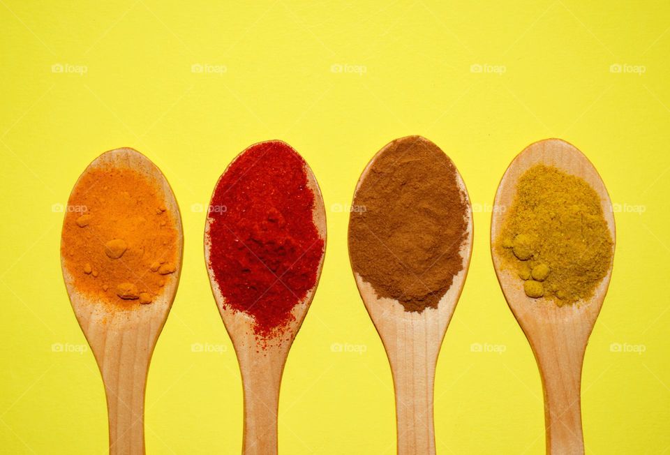 colored spices on a yellow background