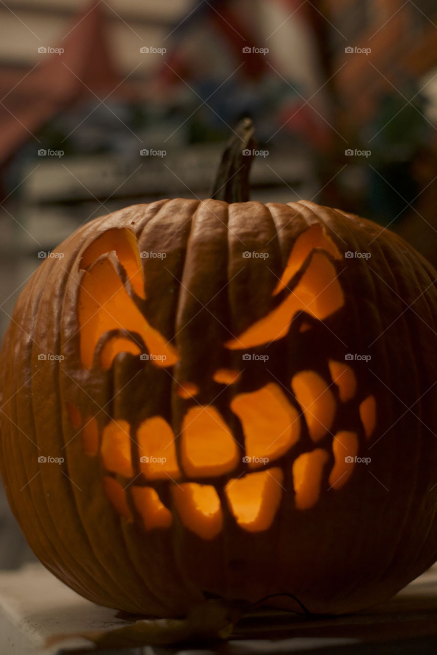 Carved Halloween jack-o’-lantern candle lit