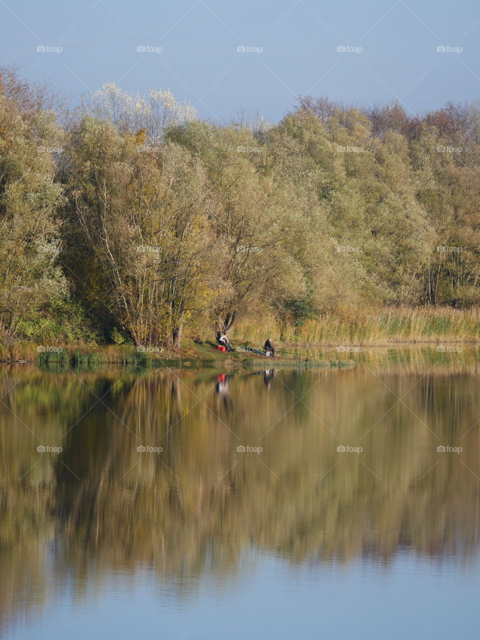 Two anglers fishing on a lake