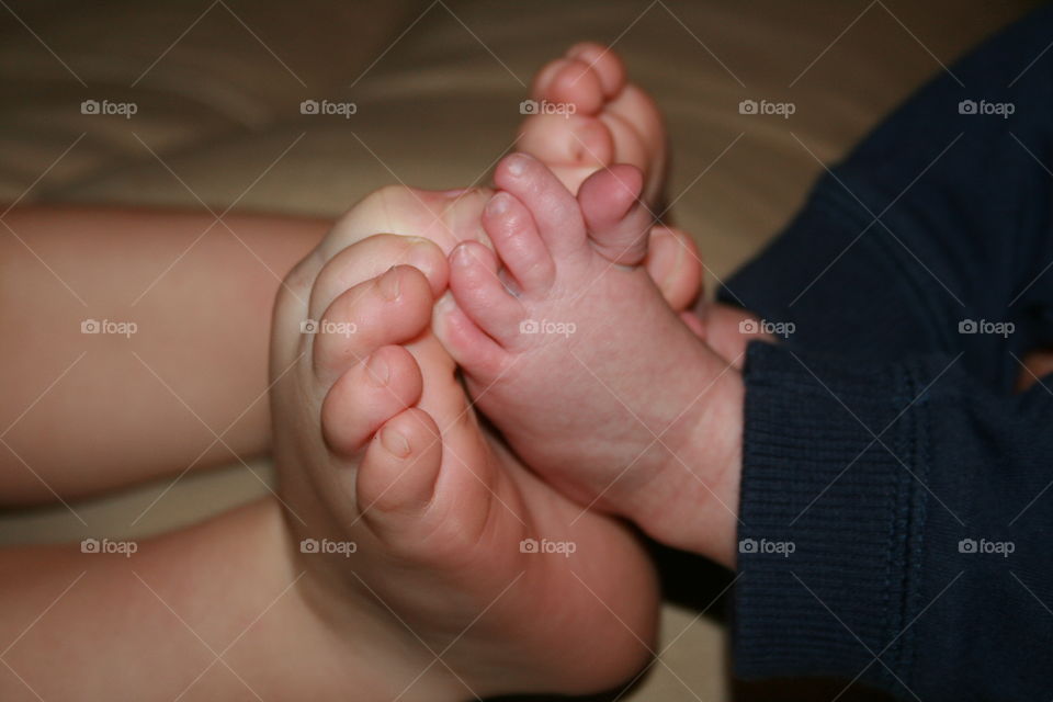 Tiny Feet. A toddler and infant siblings feet