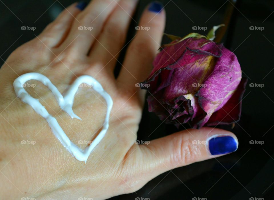 heart of cream on a female hand beauty spa