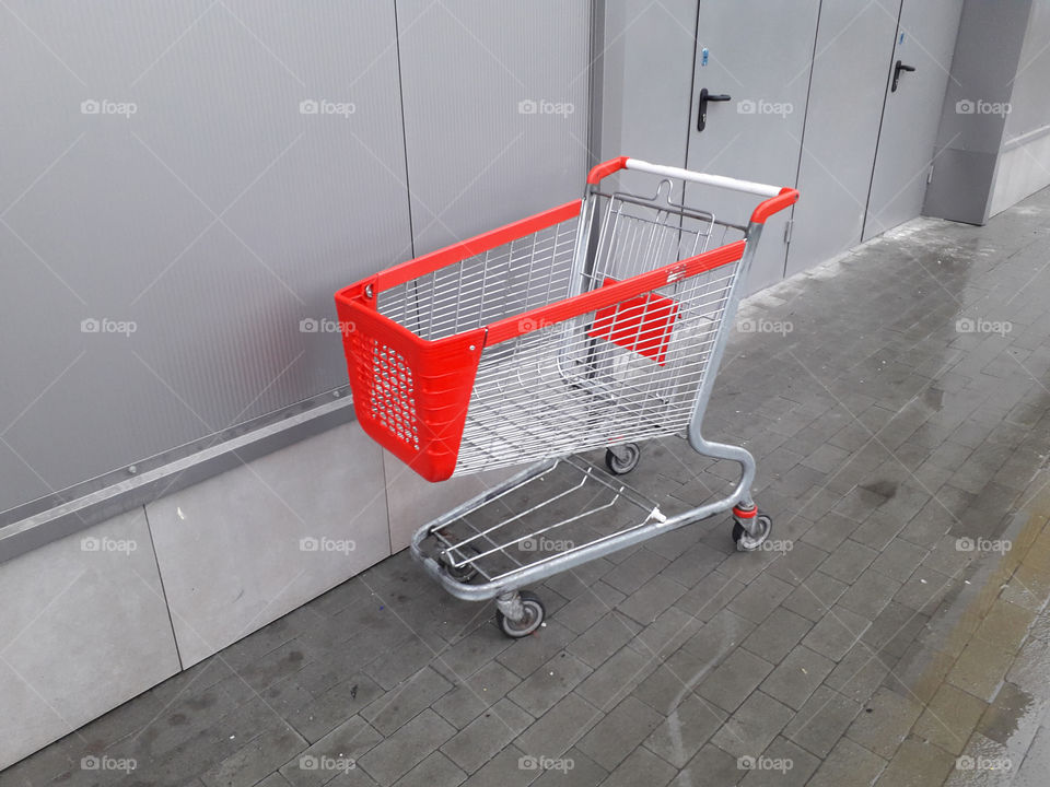 Carts for grocery products stand near a supermarket on the street