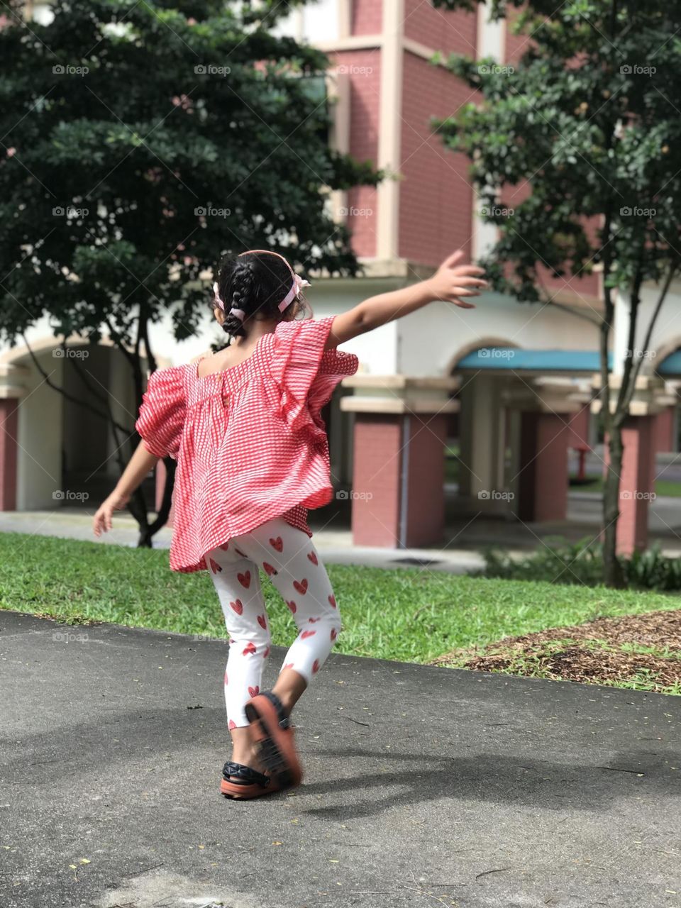 Girl turning around and her hands are extended and feels fly like a bird.