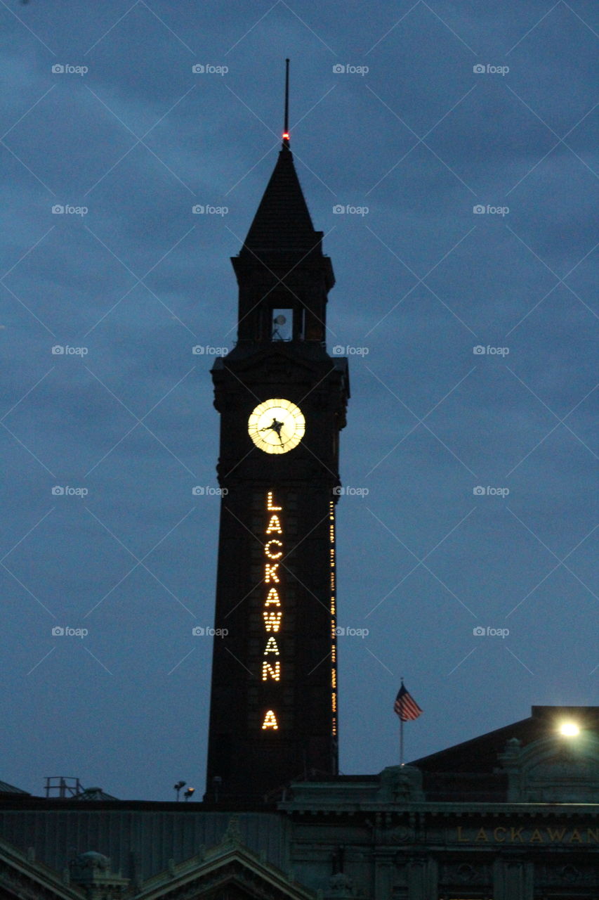 Lackawanna train terminal with lighted clock in the evening 