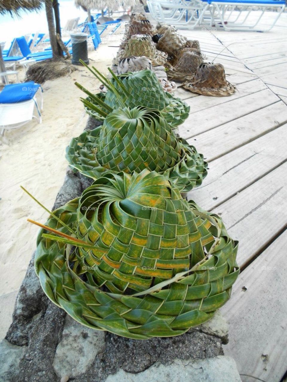 Handmade palm hats drying on the deck