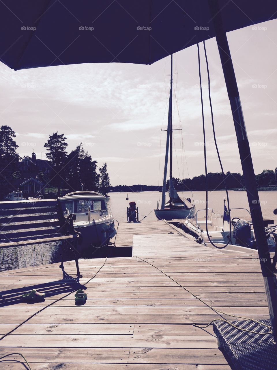 Wooden sailing boat from 1933. Our wooden sailing boat at a pier in the archipelago of Stockholm. 