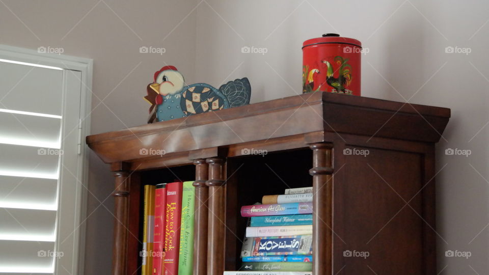 Bookcase With Vintage Rooster Tin and Wooden Chicken Basket