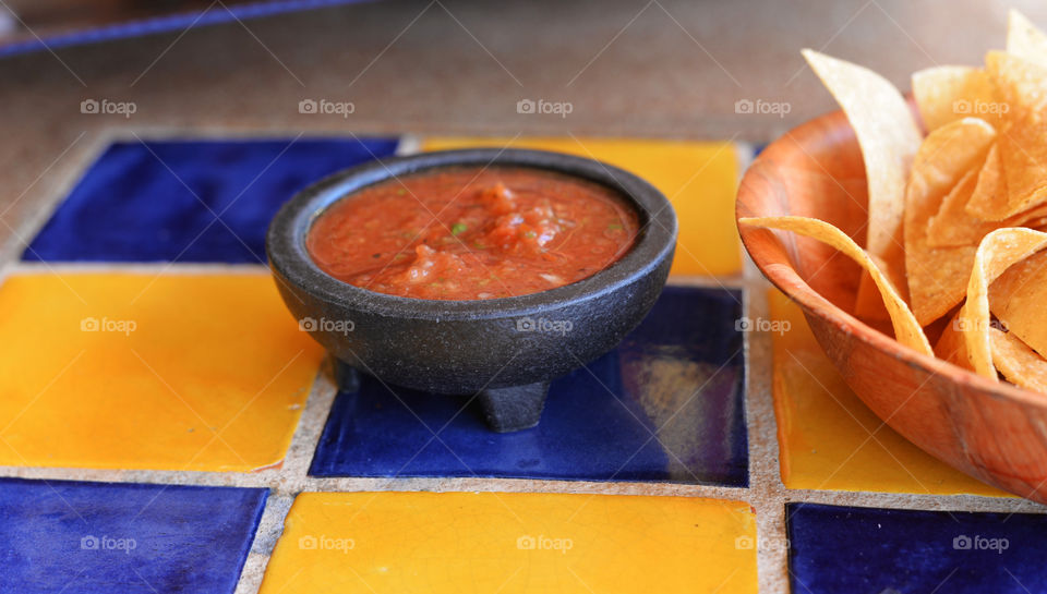 Fresh chips and salsa on a tile table
