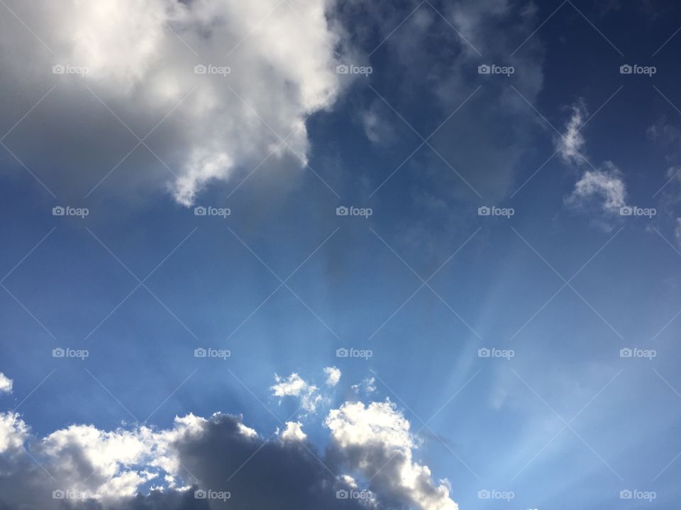 Clouds. Sun rays behind clouds. 