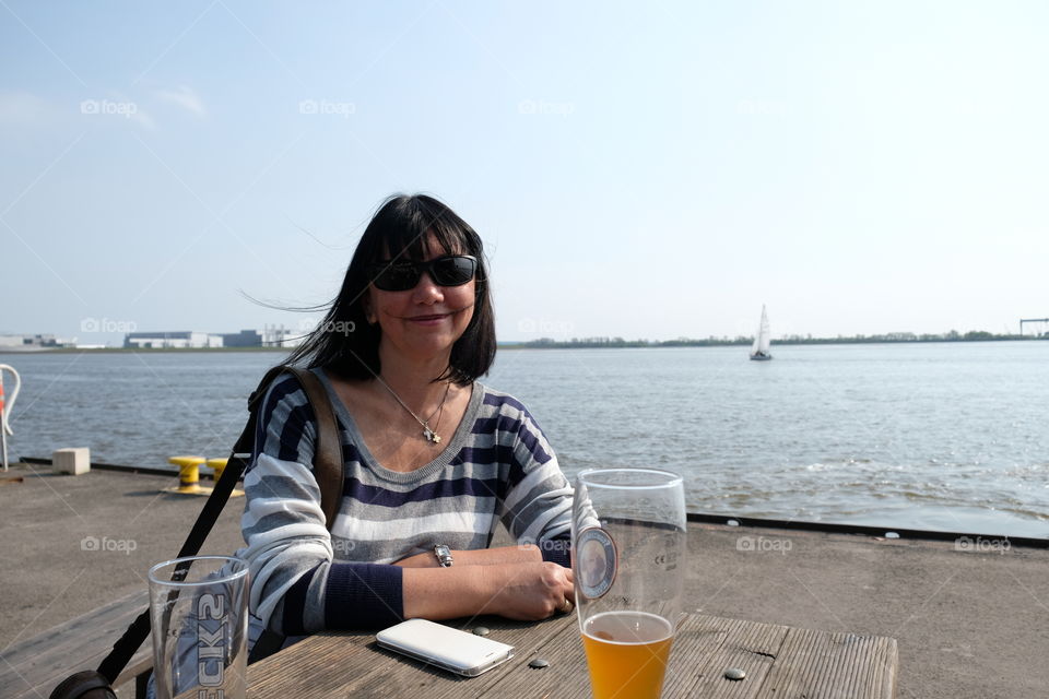 Baby boomer smiles and relaxing on the ferry dock