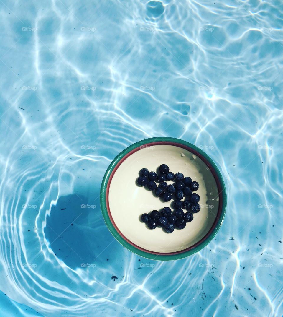 Blueberries floating in the pool. 