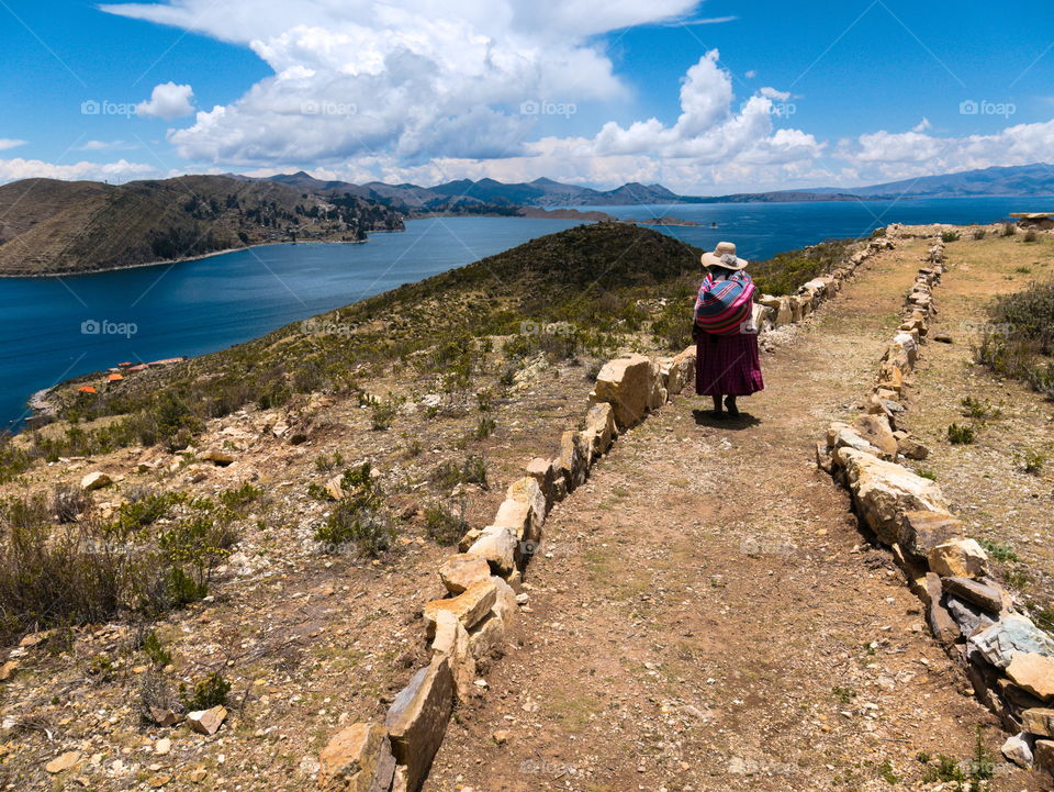 Local woman walking on a beautiful Bolivian island