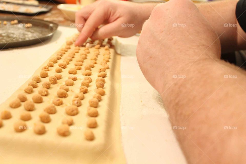 pressing the meatballs into the dough
