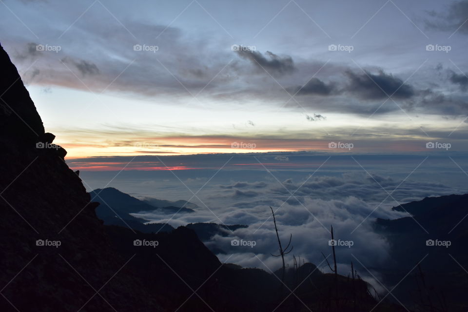 Sunset over the cloud covered peaks of ecuador