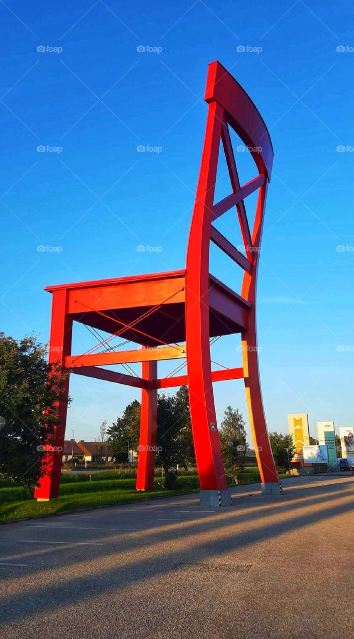 Big red chair in the city