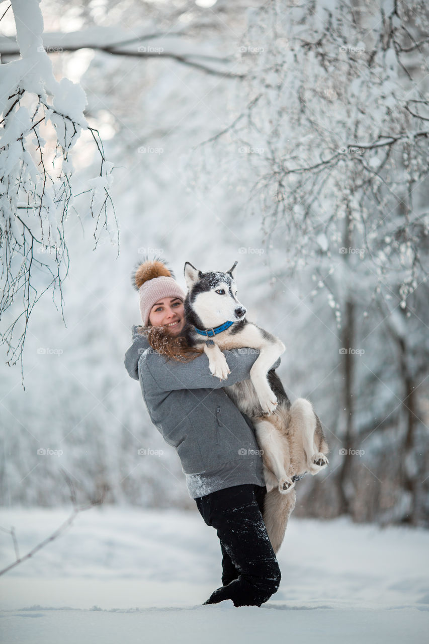 Walking with husky in winter park