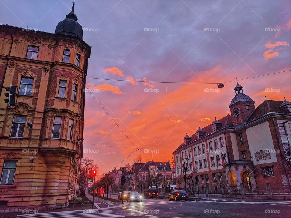 Scenic view of the bright red sunset sky in the old town of city Ljubljana, Slovenia. Winter holiday season. City life.