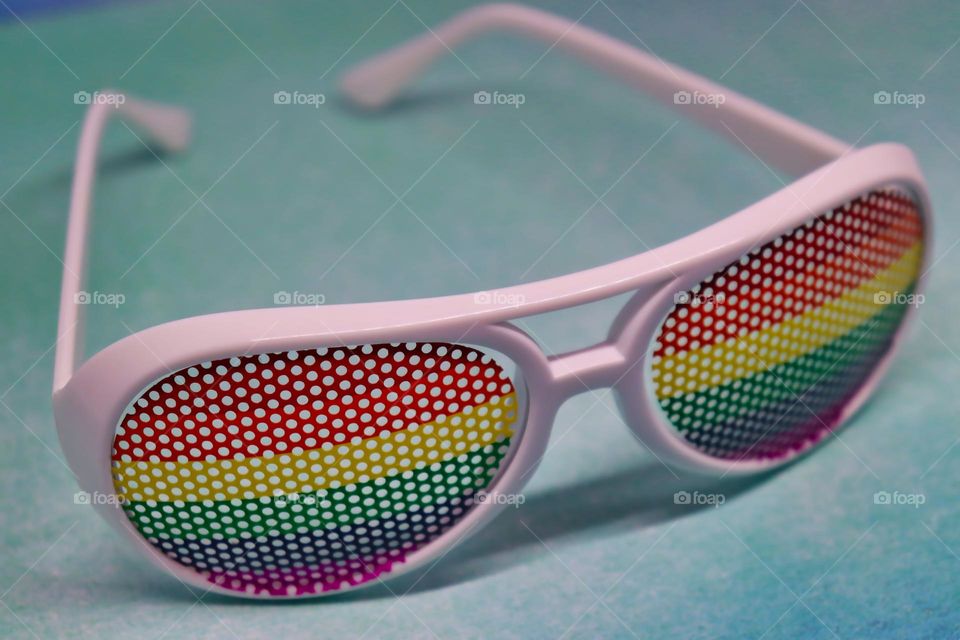 Rainbow glasses on blue background