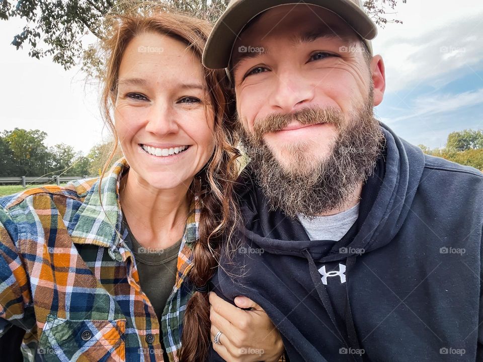 A smiling couple taking a selfie 