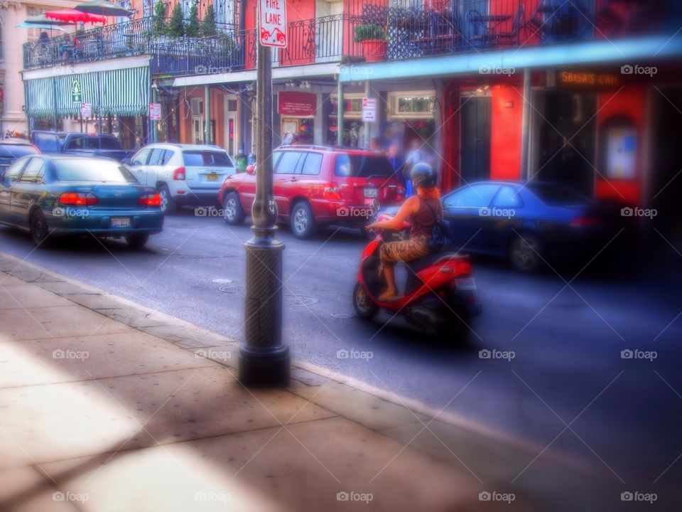 Lady riding a scooter in French Quarter