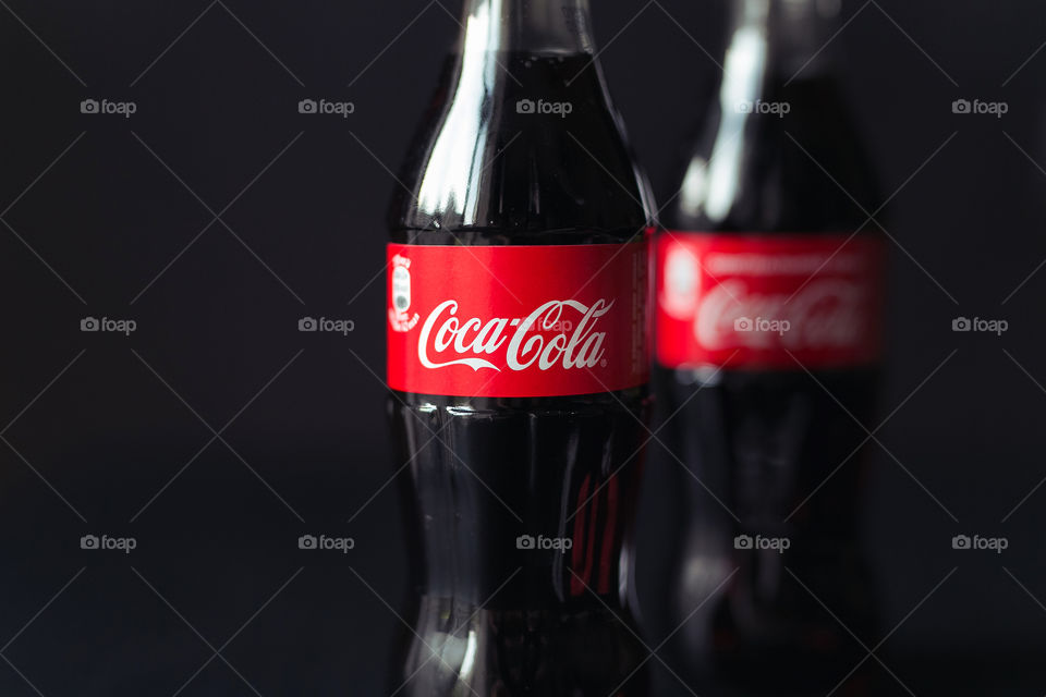 Tasty Coca-Cola, tasty drink. Black background 