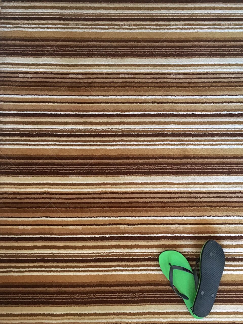 High angle view of flip flop on rug