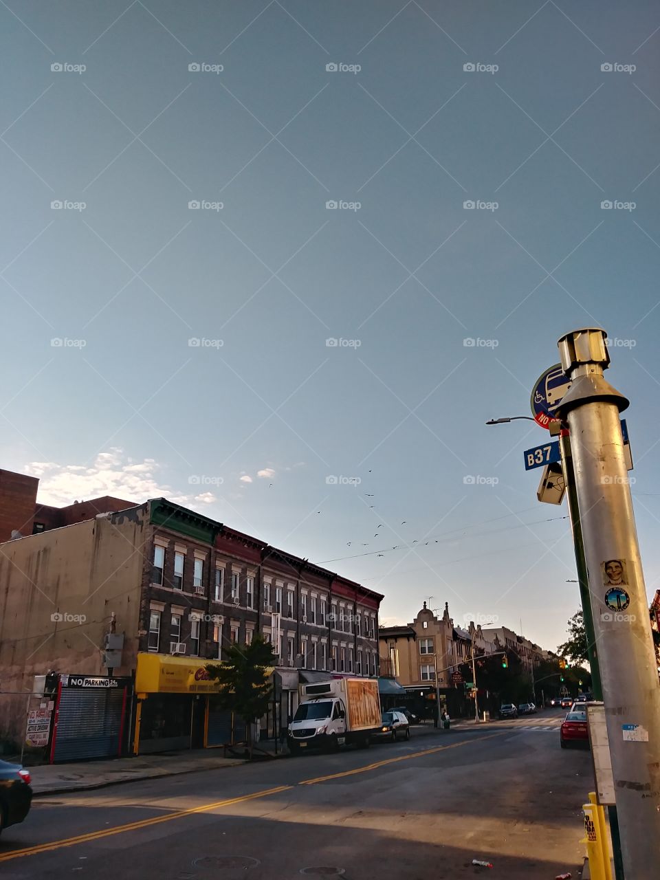 clear sky few clouds over building storefronts