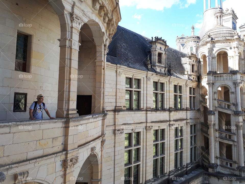 Man stands on the balcony of the old castle