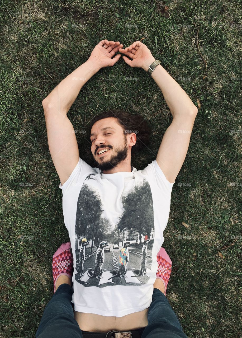 Man laying on the grass and smiling