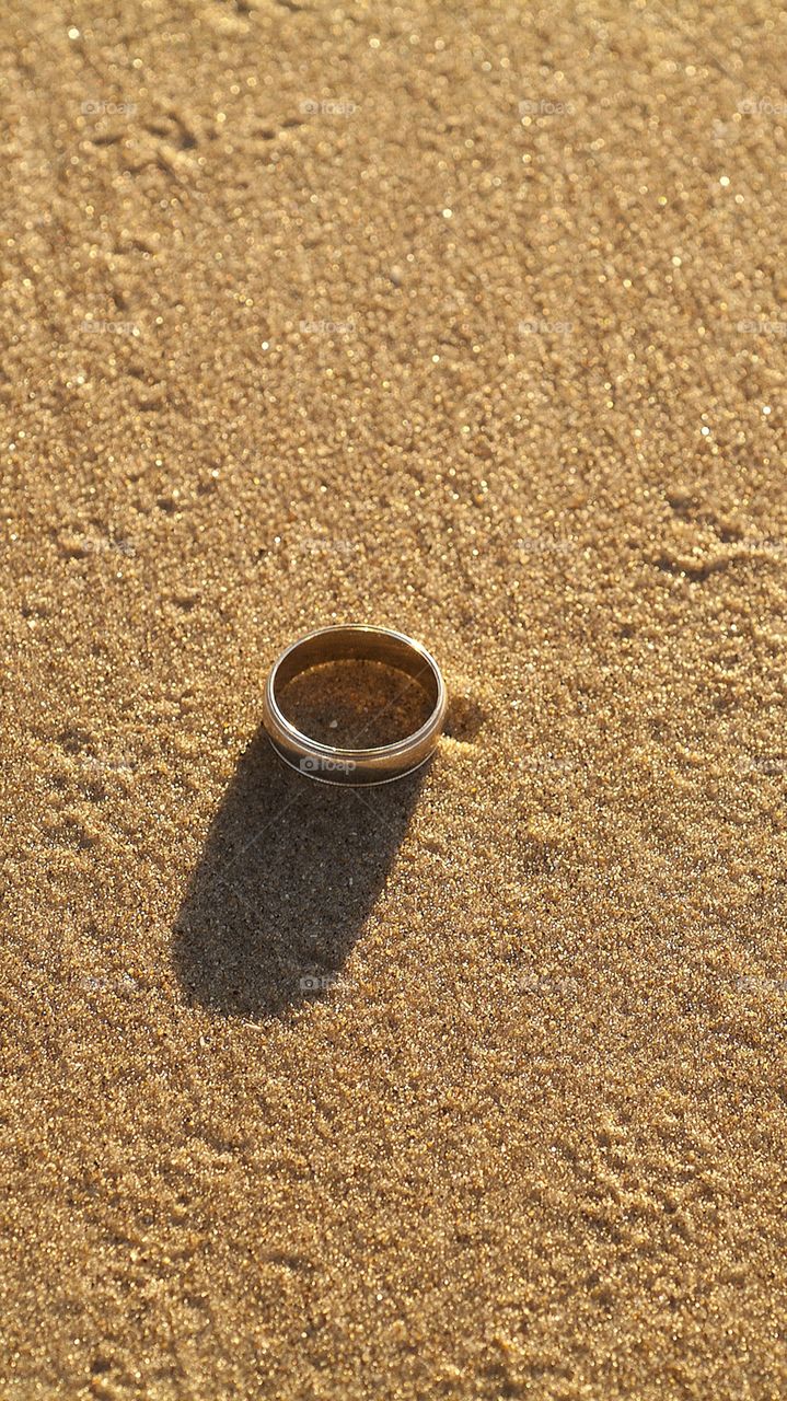 A wedding band in the sand.