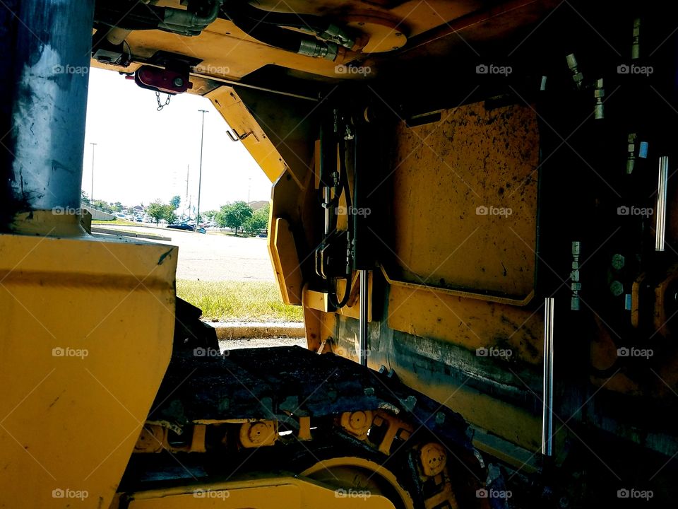 A close up look at the under belly of a large construction machine.