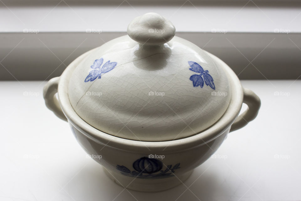 Old white blue porcelain bowl with crackled lid