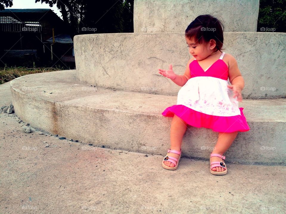 Little girl sitting in a park