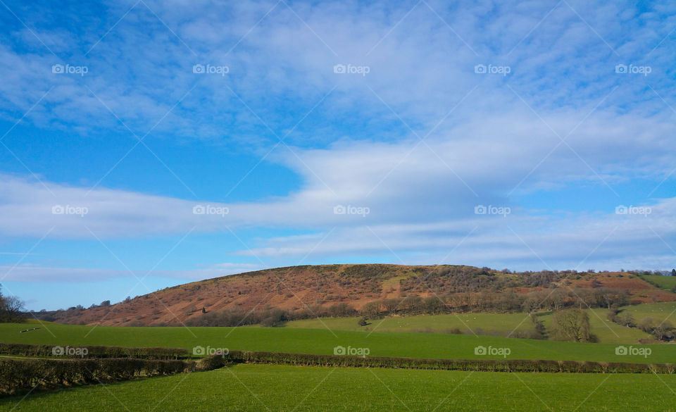 A hill, pastures and clouds near Welshpool, Powys