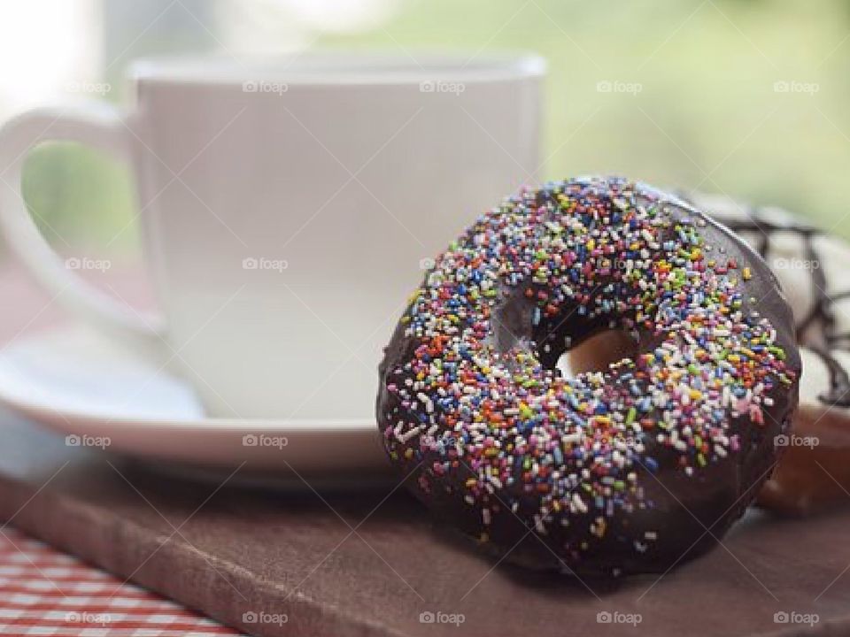 Enjoying a delicious cup of coffee with a donut.