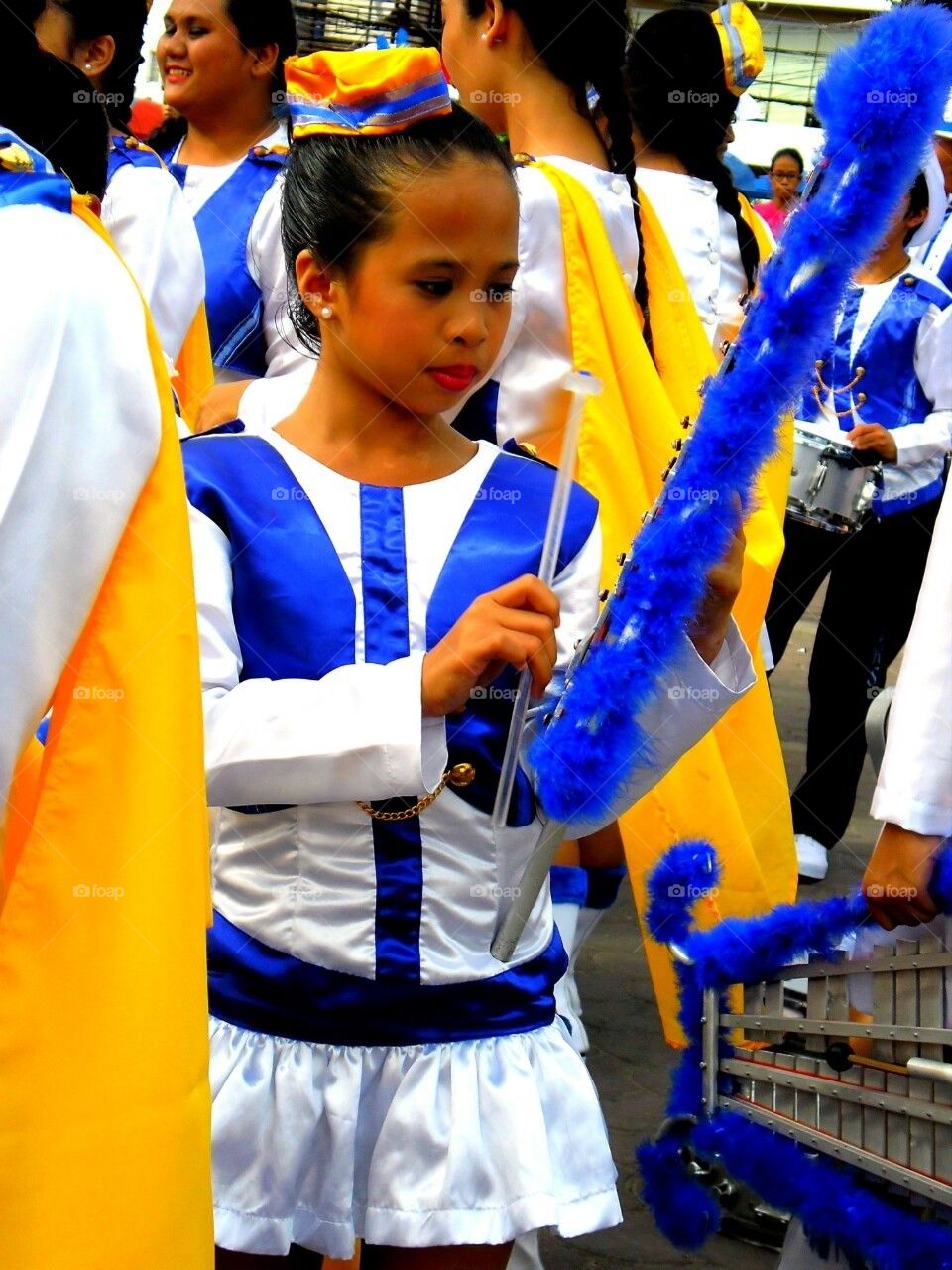 Member of a marching band playing the xylophone at a feast in