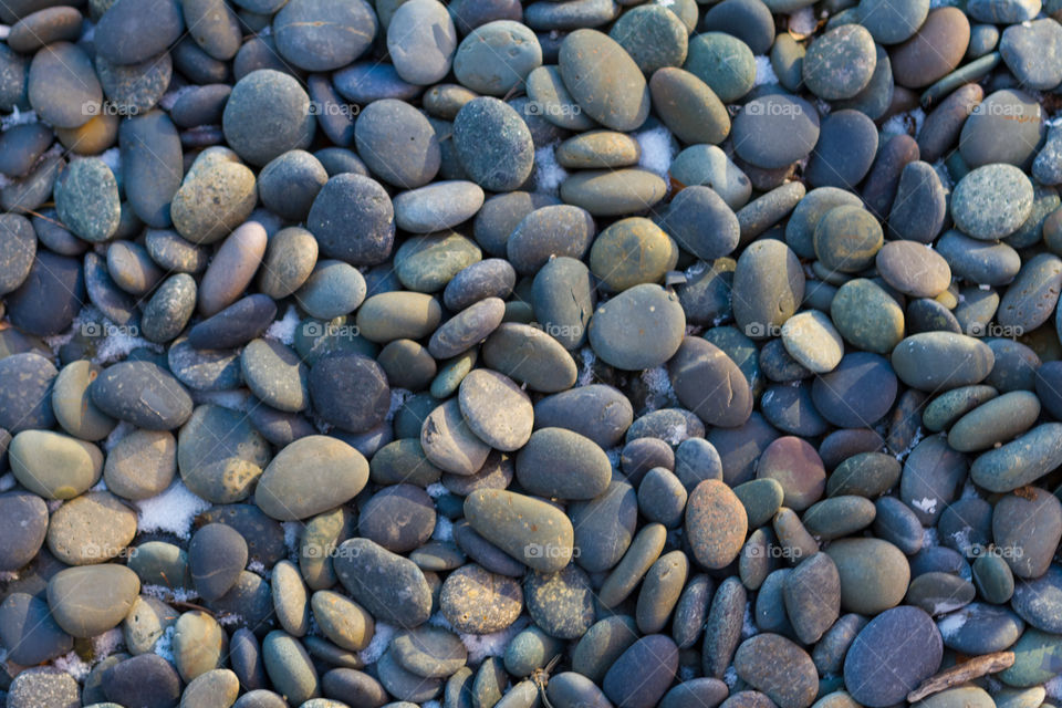 river rocks with snow