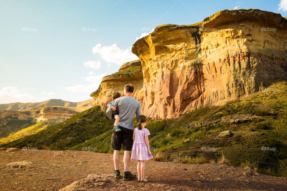 2019 a year of special memories! Image of husband and children overlooking majestic sandstone mountains. Image from Clarens South Africa