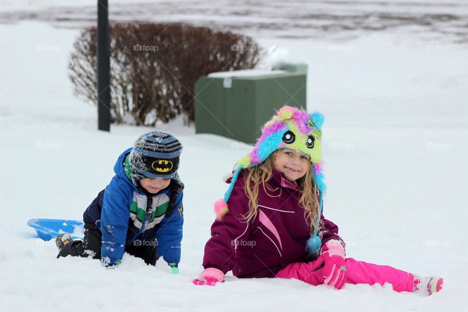 Brother and sister playing snow